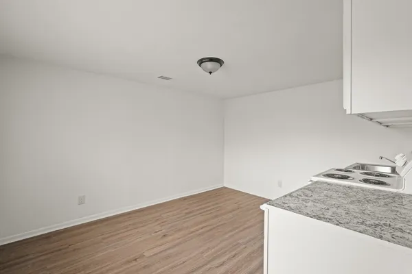 a view of a kitchen cabinets and wooden floor