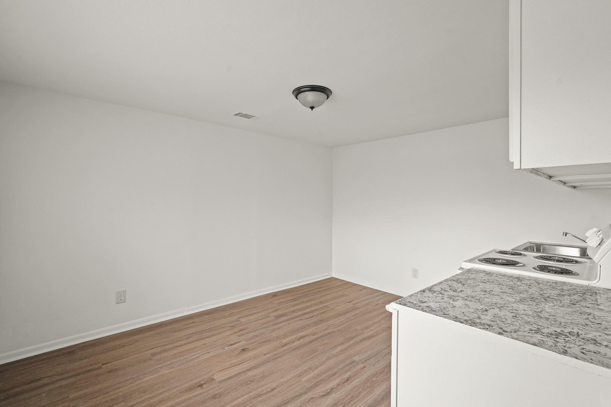 105 West Linney Street, Unit 3 Dayton, TX 77535 - Photo 10 of 12 a view of a kitchen cabinets and wooden floor