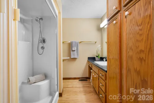 a bathroom with a granite countertop sink a toilet and shower