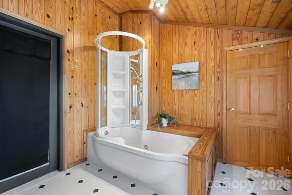 a bathroom with a tub a sink and a shower