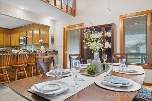 a living room with furniture and a dining table
