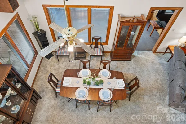 a dining room with furniture and wooden floor