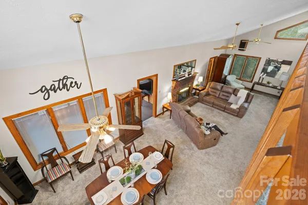 a view of gym equipment and living room with windows