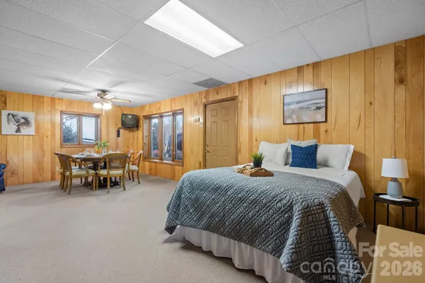 a spacious bedroom with a bed and a chandelier