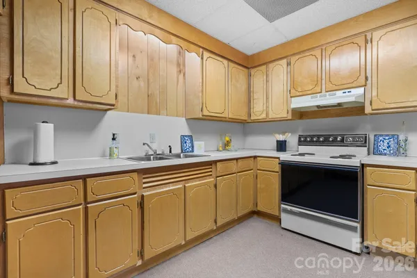 a kitchen with stainless steel appliances granite countertop a sink and cabinets