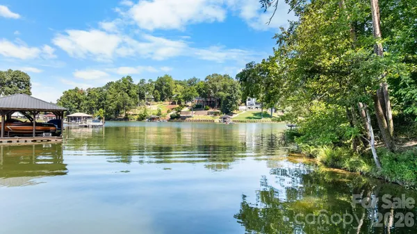 a view of a lake with houses in the background
