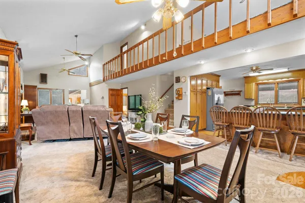 a dining hall with stainless steel appliances a dining table and chairs with wooden floor