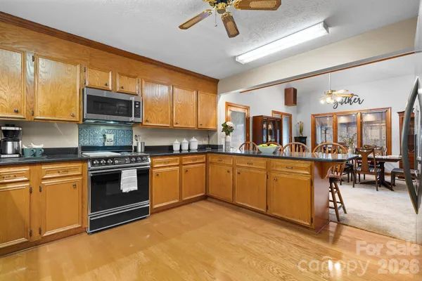 a kitchen with stainless steel appliances granite countertop a stove and cabinets