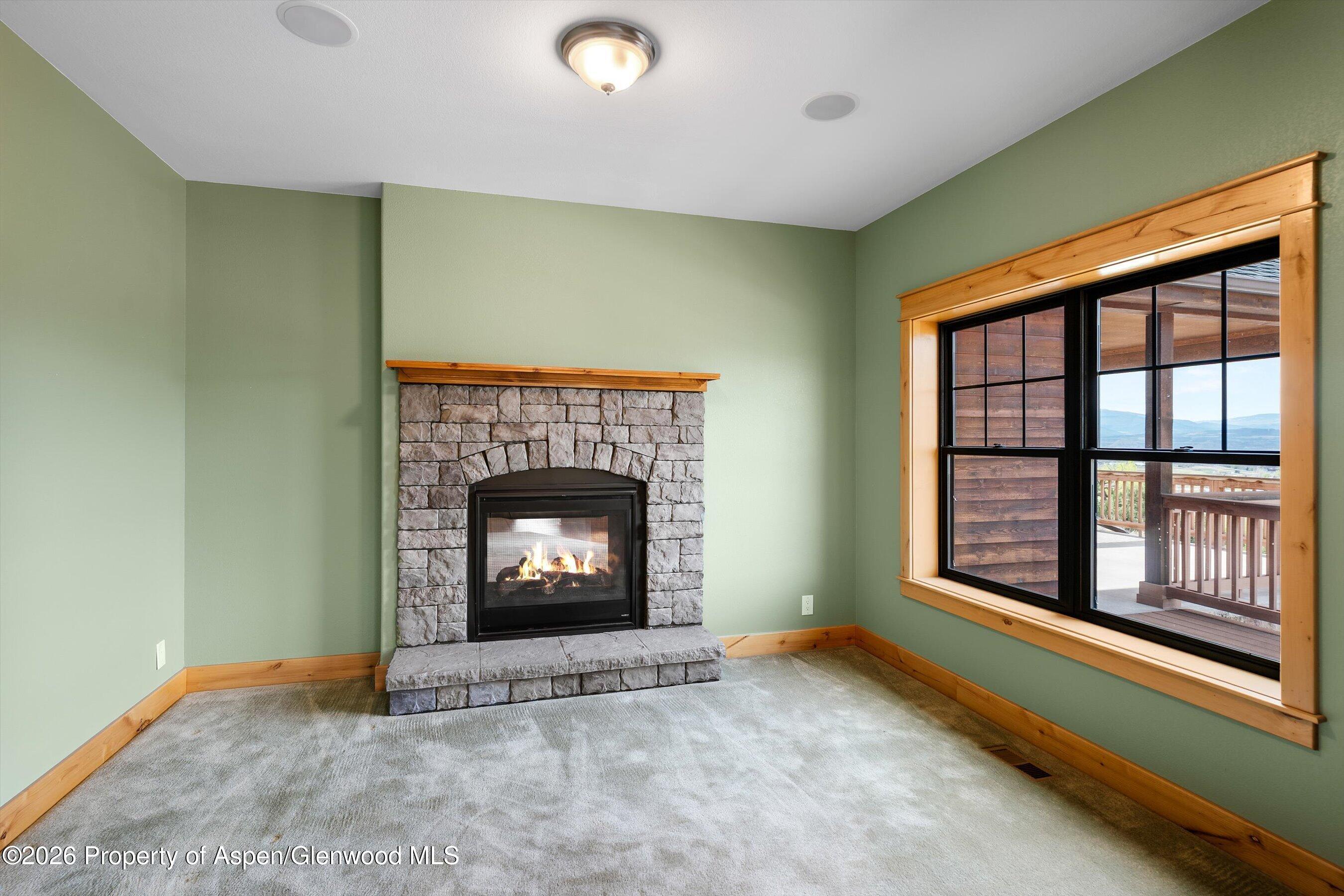 450 Summer Falls Road Silt, CO 81652 - Photo 16 of 50 a view of an empty room with a fireplace and a window