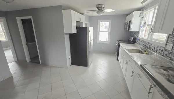 a kitchen with a sink stove and refrigerator