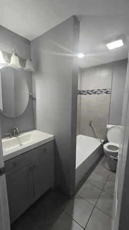 a bathroom with a sink toilet and tub