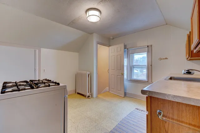 a kitchen that has a sink stainless steel appliances counter space and a window