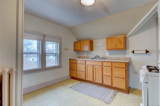 a spacious bathroom with a granite countertop sink and a mirror