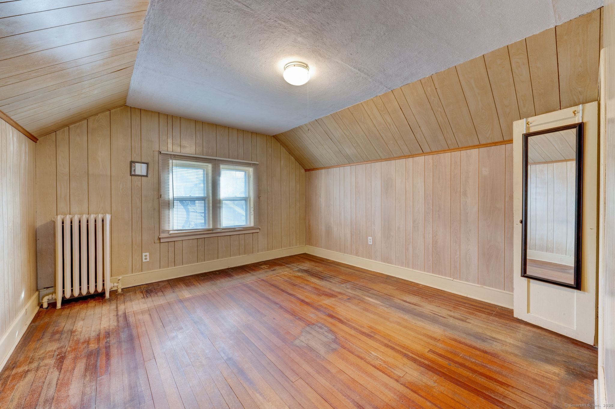 18 Hubbard Place Wethersfield, CT 06109 - Photo 5 of 21 an empty room with wooden floor and windows