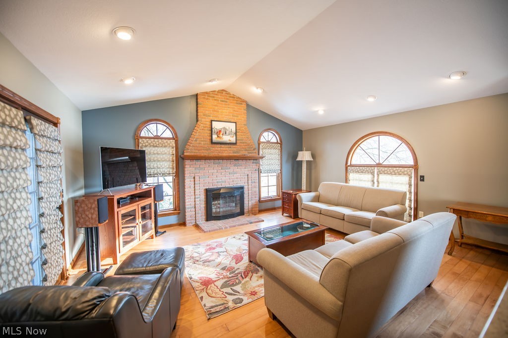 4848 Fette Road Dennison, OH 44621 - Photo 17 of 48 Living area with hardwood floors, natural light, and a brick fireplace