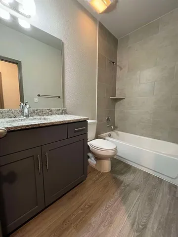 a bathroom with a double vanity sink toilet and shower