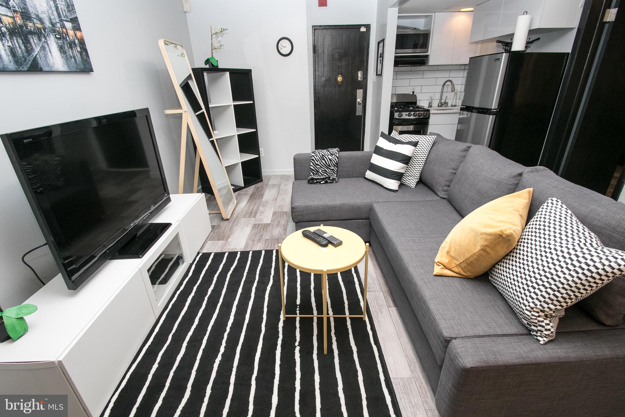 2135 Walnut Street, Unit 304 Philadelphia, PA 19103 - Photo 2 of 5 a view of a living room with furniture