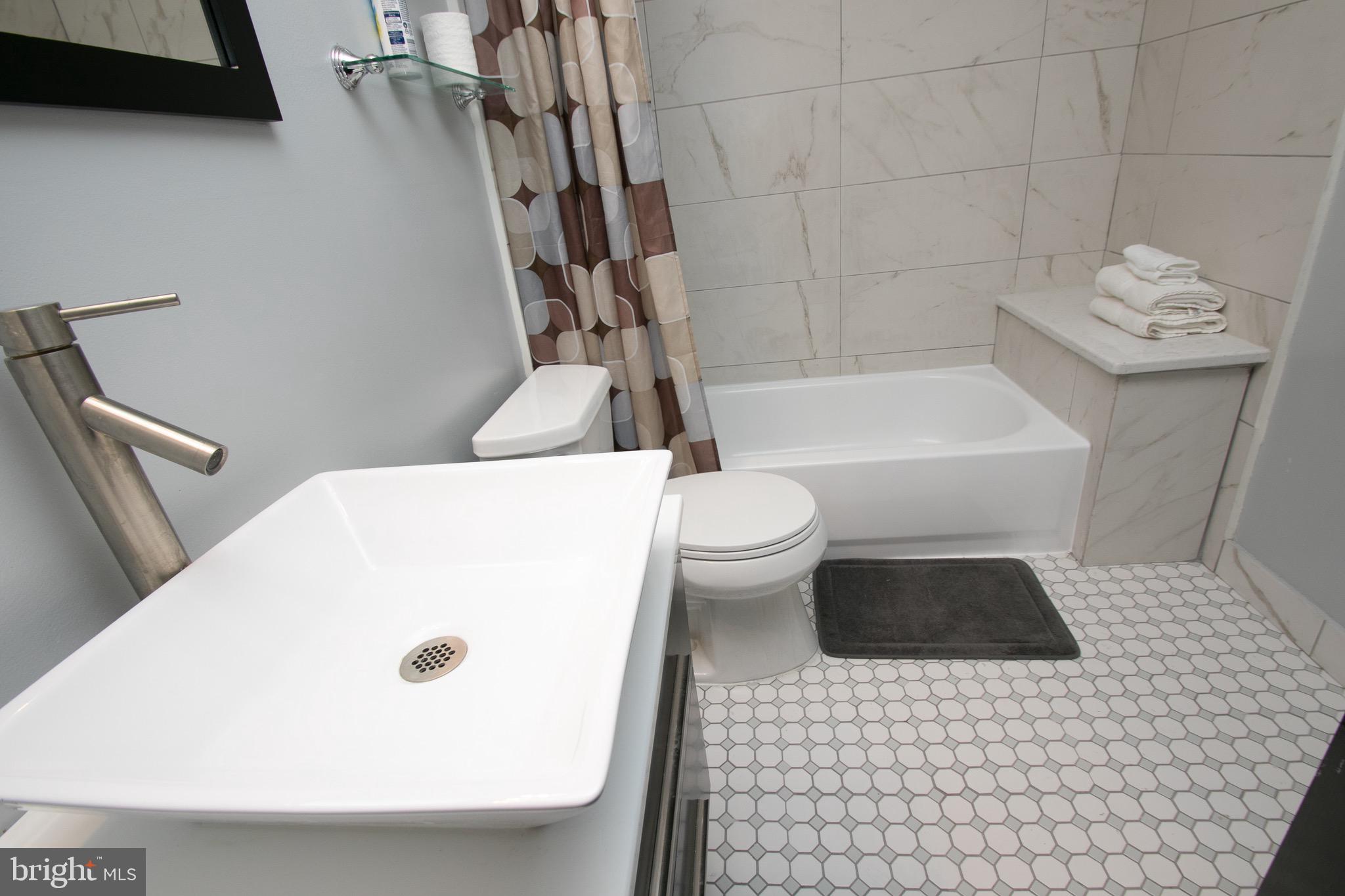 2135 Walnut Street, Unit 304 Philadelphia, PA 19103 - Photo 5 of 5 a bathroom with a sink a toilet and bathtub