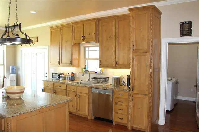 a bathroom with a granite countertop sink a mirror and a shower