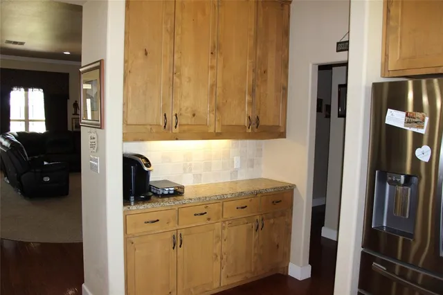 a kitchen with a refrigerator and cabinets