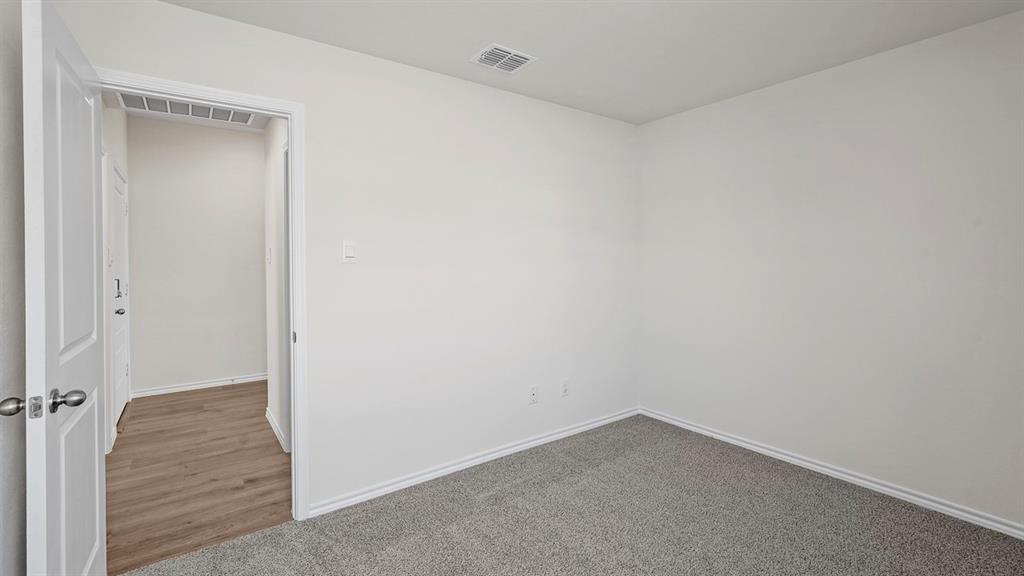 1675 Mantle Road Crandall, TX 75114 - Photo 23 of 27 Interior room featuring light gray carpet flooring, white walls, and white baseboards