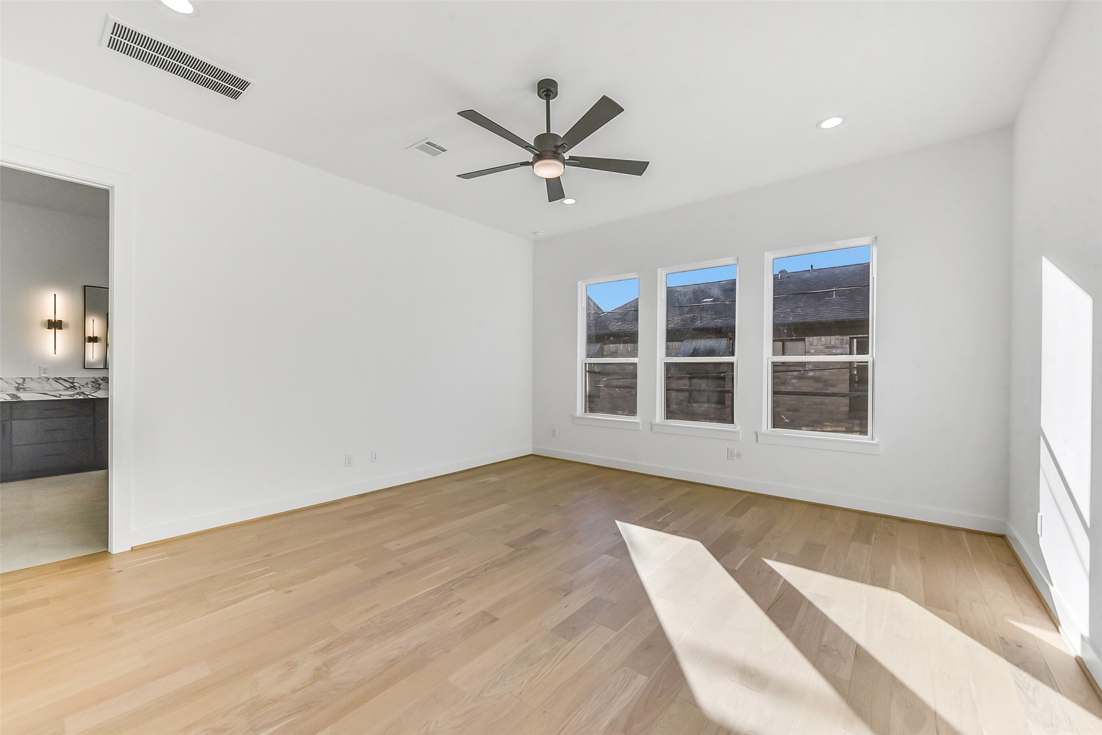 1902 Nantucket Drive Houston, TX 77057 - Photo 14 of 50 a view of a room with wooden floor and windows