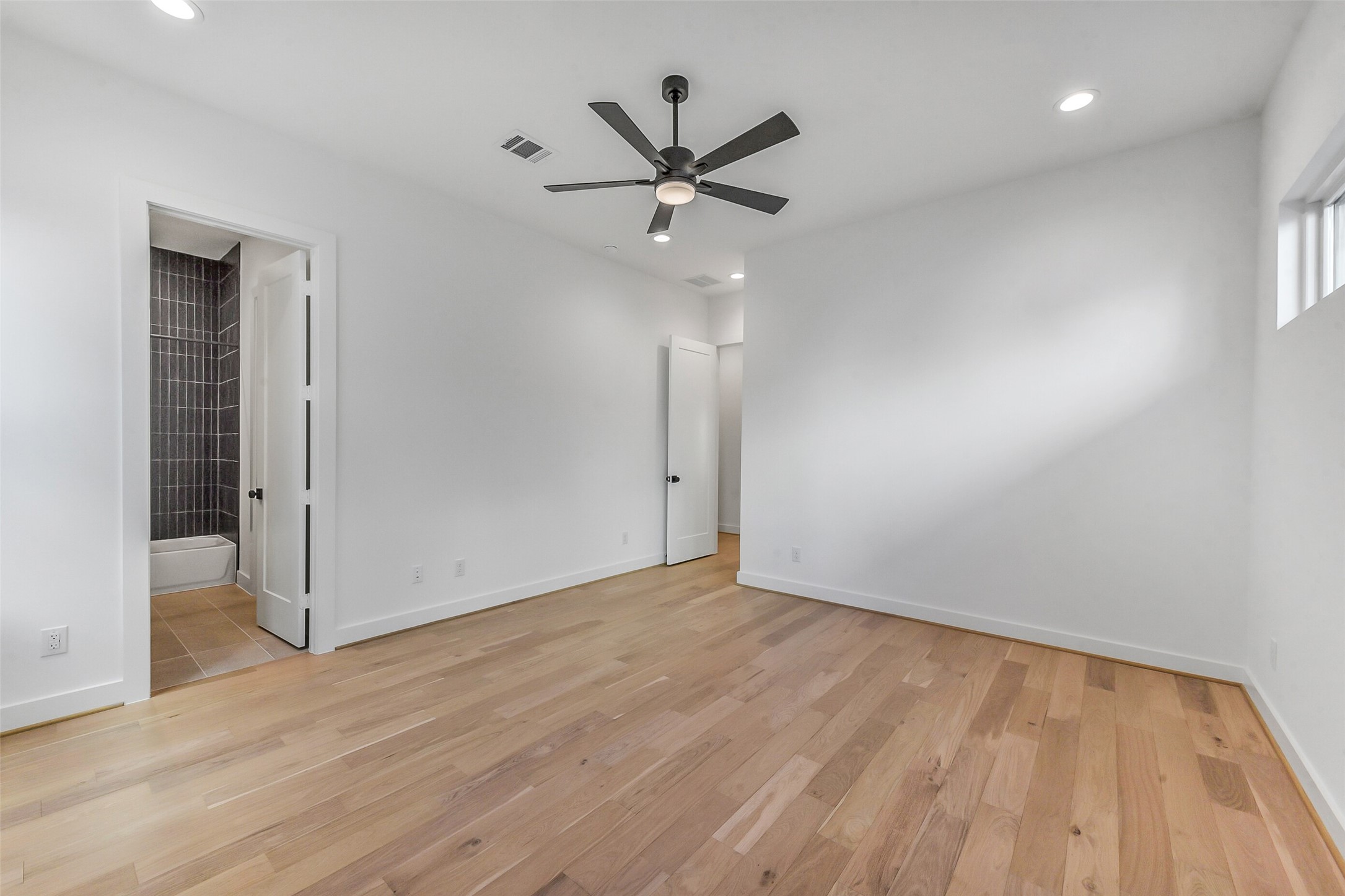1902 Nantucket Drive Houston, TX 77057 - Photo 22 of 50 wooden floor in an empty room with a window