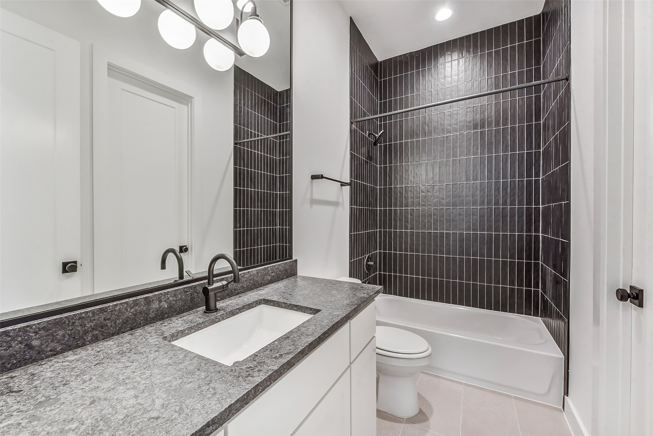 1902 Nantucket Drive Houston, TX 77057 - Photo 23 of 50 a bathroom with a granite countertop sink a toilet and shower