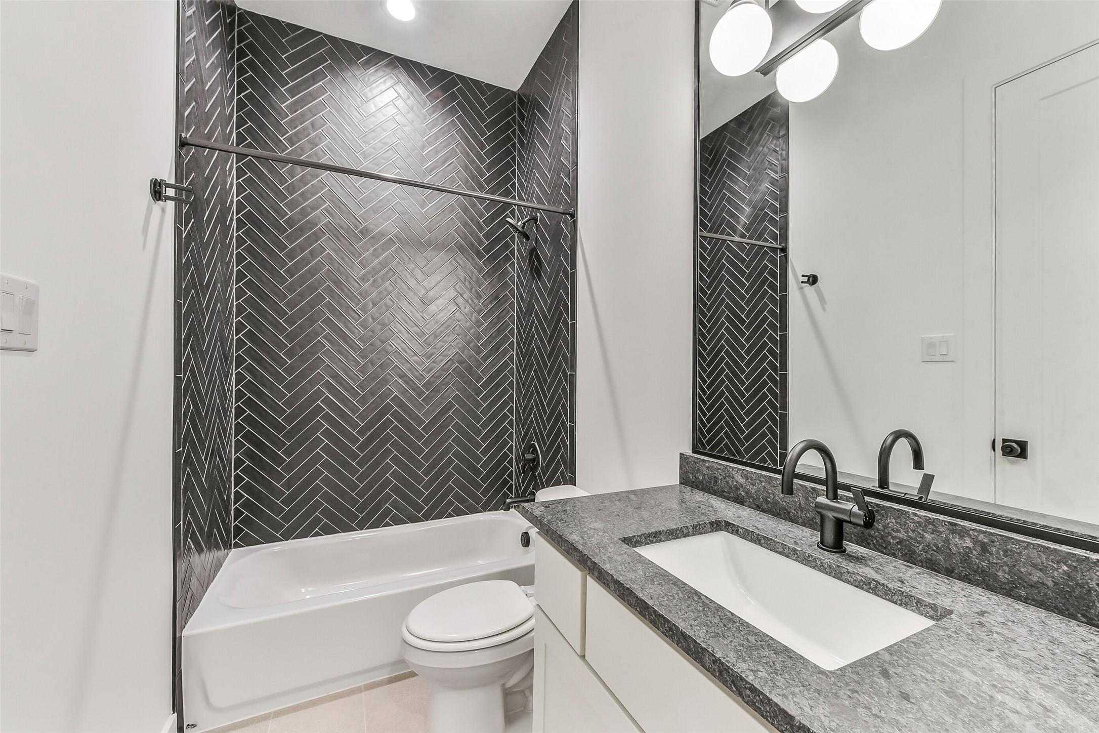 1902 Nantucket Drive Houston, TX 77057 - Photo 26 of 50 a bathroom with a granite countertop sink a toilet and bathtub
