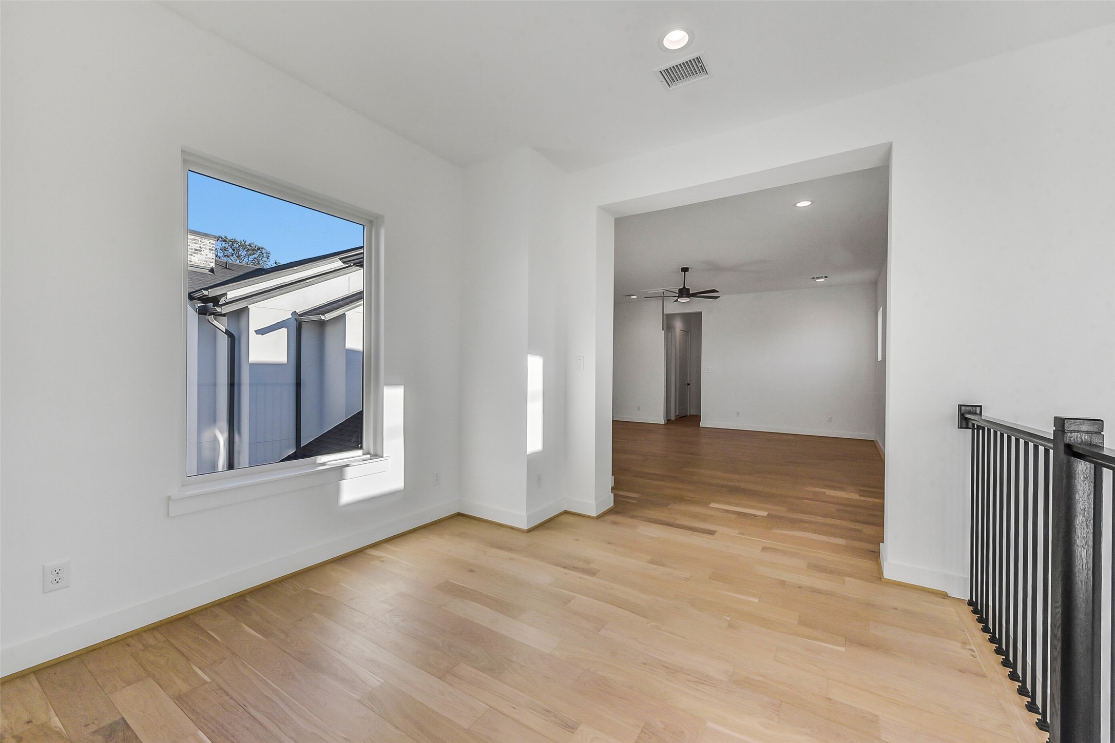 1902 Nantucket Drive Houston, TX 77057 - Photo 28 of 50 a view of an empty room with wooden floor and a window