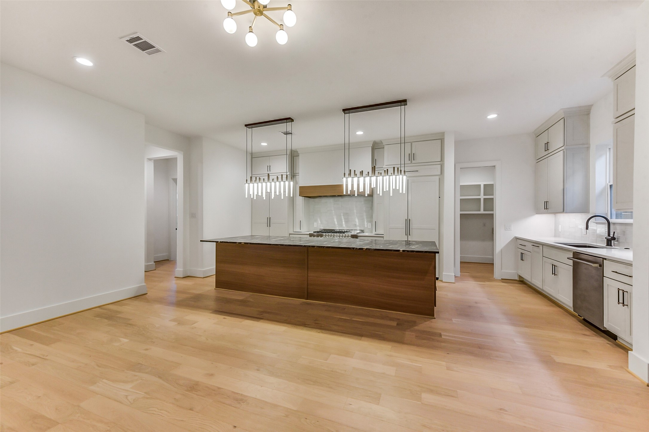 1902 Nantucket Drive Houston, TX 77057 - Photo 37 of 50 a large room with kitchen island a sink stainless steel appliances and cabinets