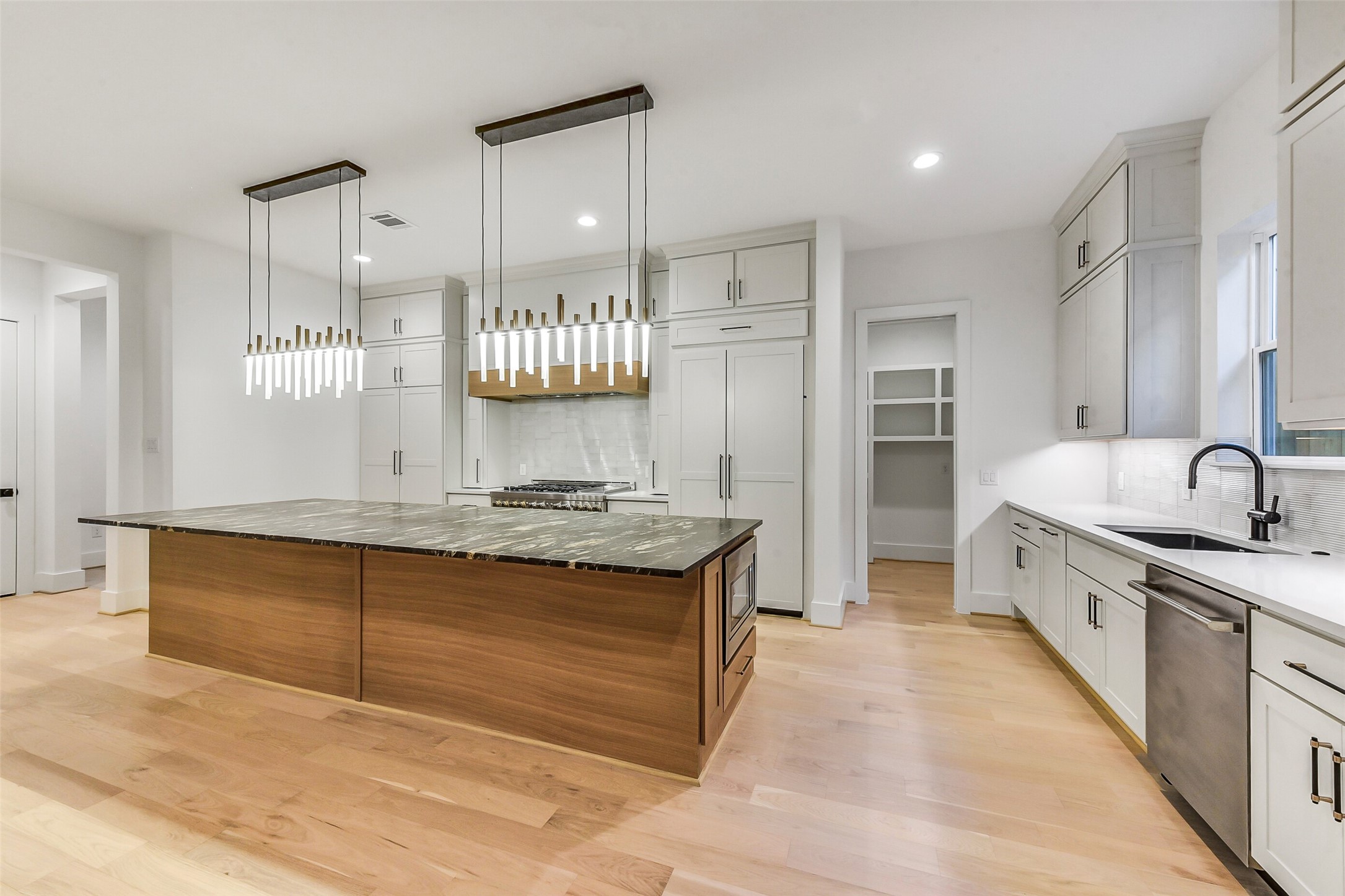 1902 Nantucket Drive Houston, TX 77057 - Photo 39 of 50 a large kitchen with kitchen island a sink stainless steel appliances and cabinets
