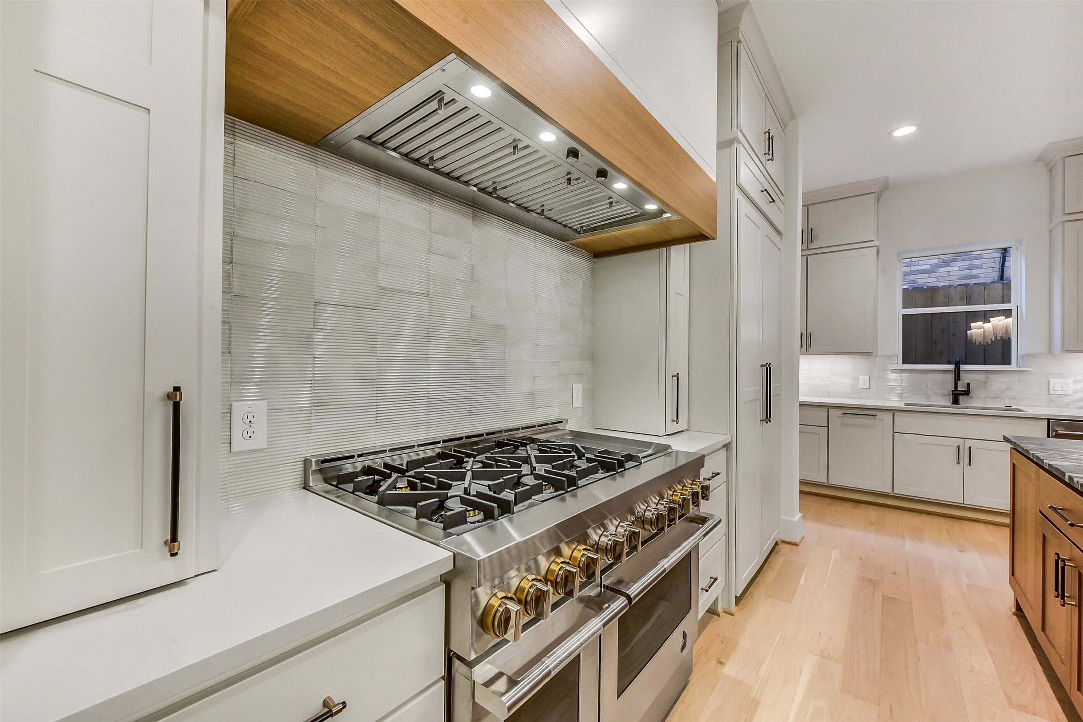 1902 Nantucket Drive Houston, TX 77057 - Photo 45 of 50 a kitchen with a stove a sink and a refrigerator