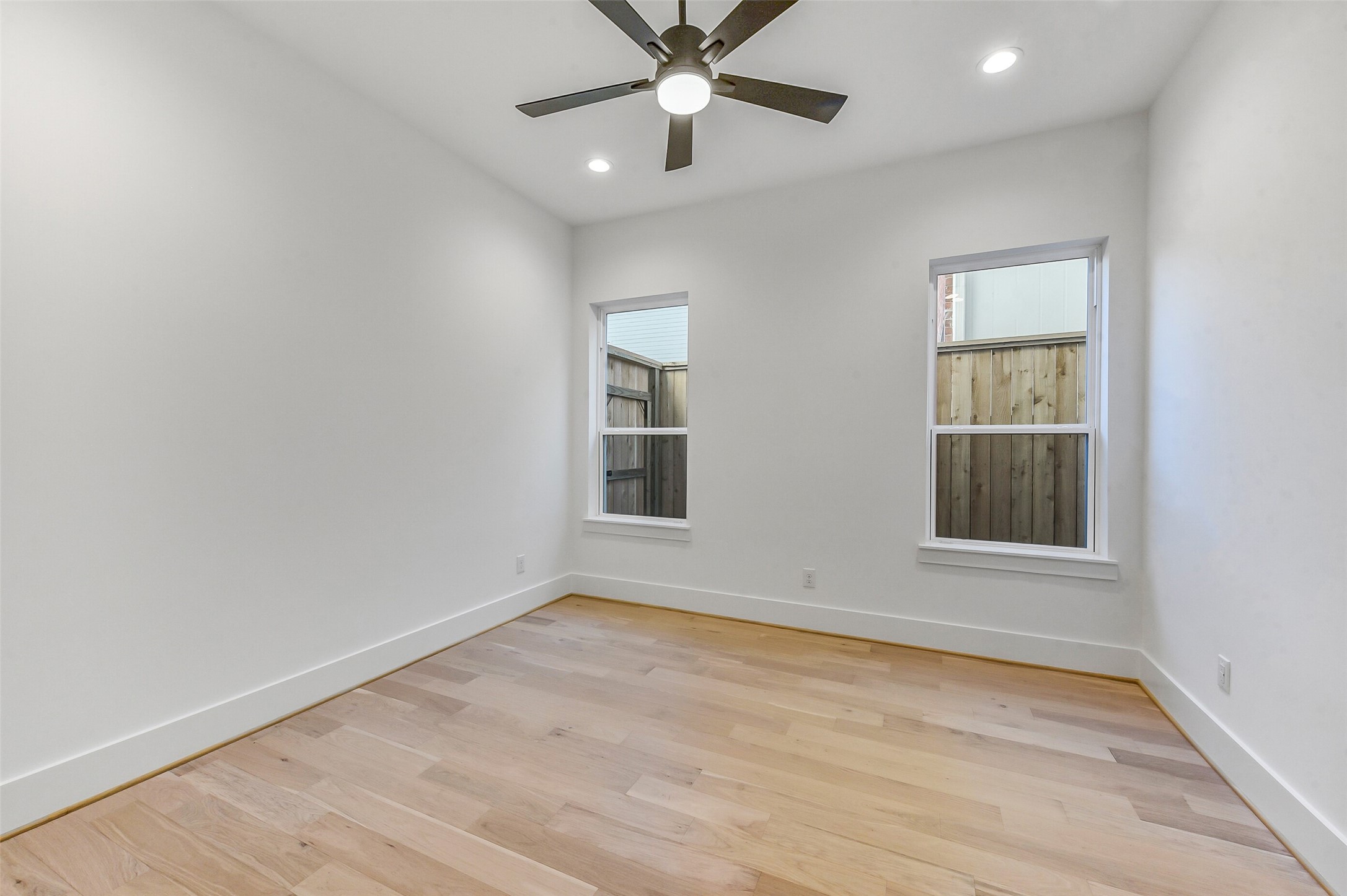 1902 Nantucket Drive Houston, TX 77057 - Photo 47 of 50 an empty room with a window and ceiling fan