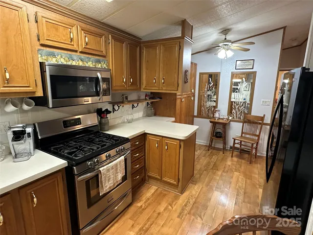 a kitchen with a stove a sink and a microwave