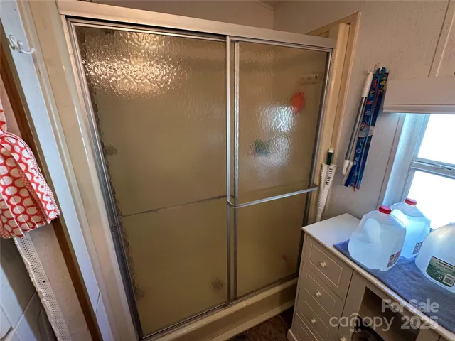 a bathroom with a shower and a sink