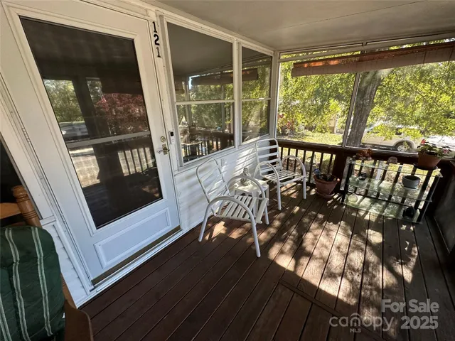 a view of a chairs and table in the balcony