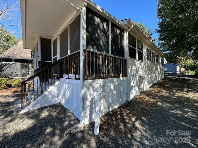 a view of a balcony with wooden floor and fence