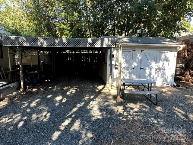 a front view of a house with yard and sitting area