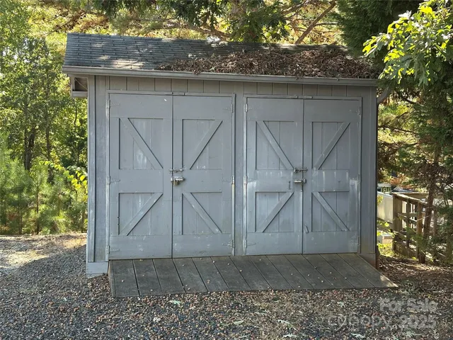 an aerial view of a house with a yard and lake view