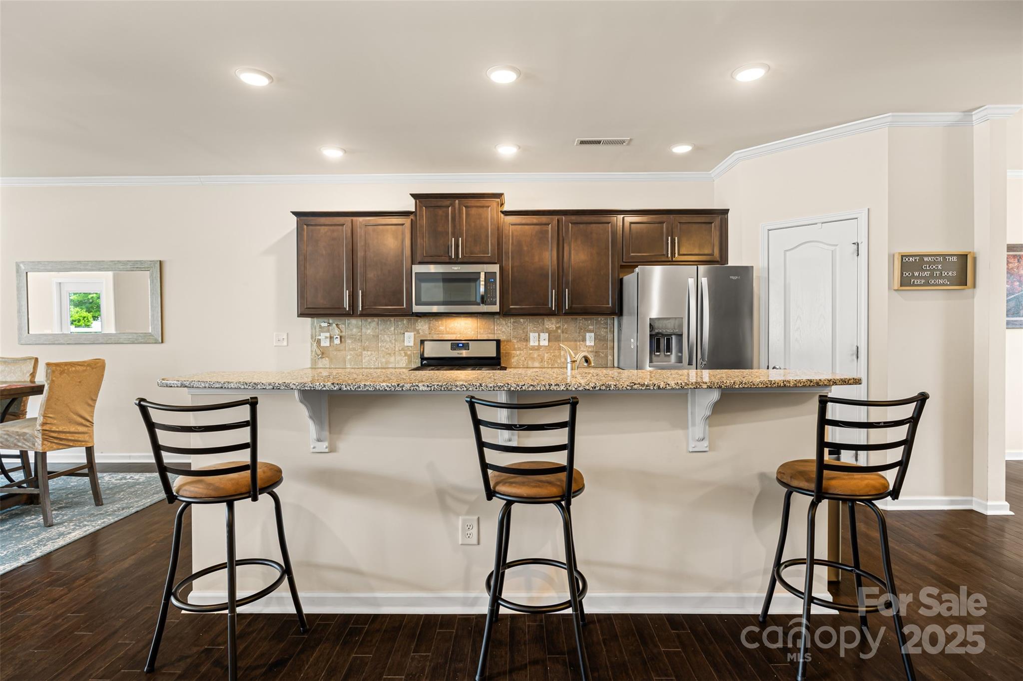 269 Keating Pl Drive Fort Mill, SC 29708 - Photo 16 of 48 a kitchen with stainless steel appliances kitchen island granite countertop a refrigerator and a stove top oven with wooden floor