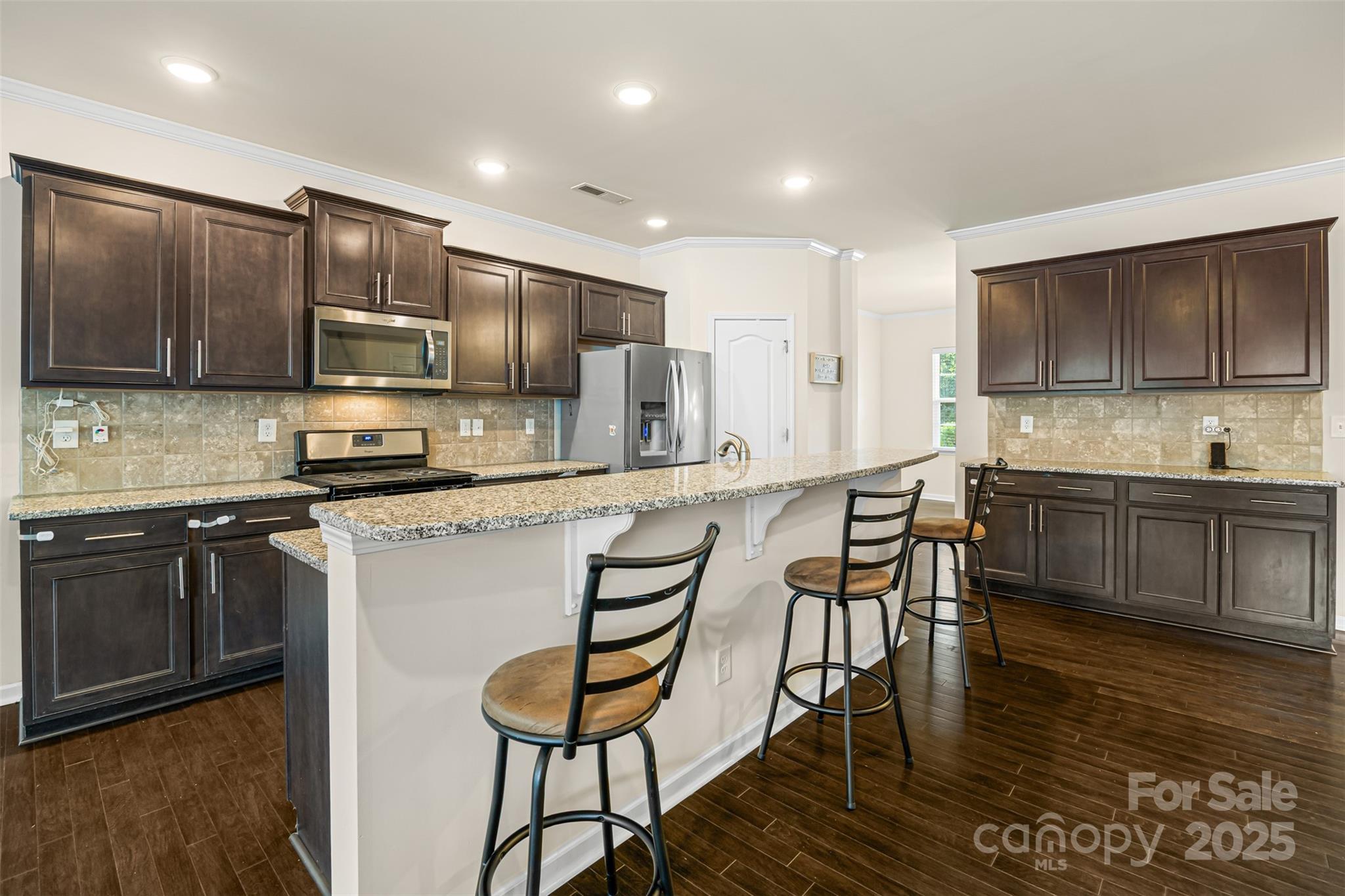 269 Keating Pl Drive Fort Mill, SC 29708 - Photo 17 of 48 a kitchen with kitchen island granite countertop wooden cabinets and stainless steel appliances