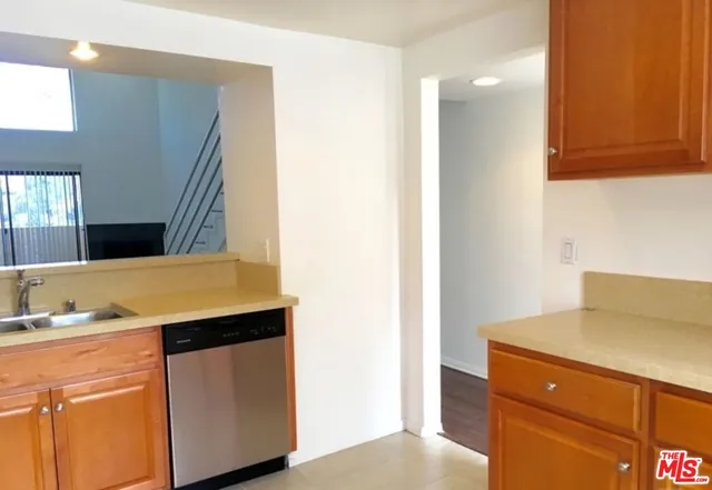 a kitchen with a sink and a refrigerator