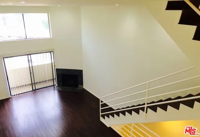 a view of a room with wooden floor and windows