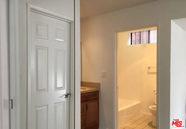 a view of a bathroom from a hallway