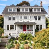 a front view of a house with a garden