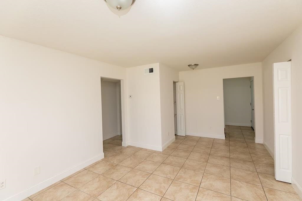 3236 Millington Road Memphis, TN 38127 - Photo 10 of 31 Spacious interior room featuring neutral tile flooring, white walls, and a semi-flush mount ceiling light