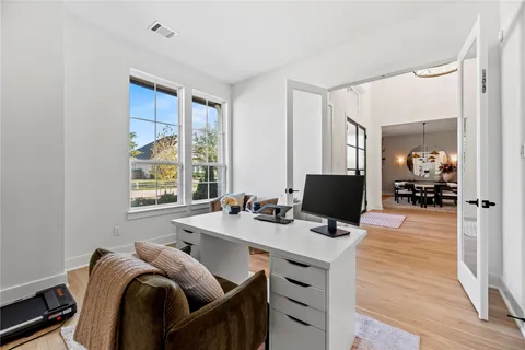 a view of a workspace with furniture and a window