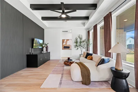 a large bedroom with a bed and wooden floor