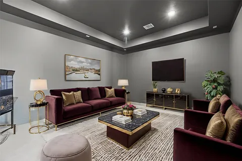 a living room with furniture a rug and a flat screen tv